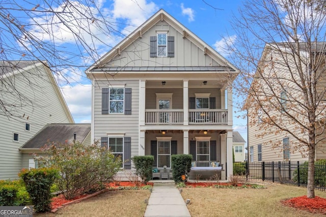 view of front of home featuring a balcony and a front yard