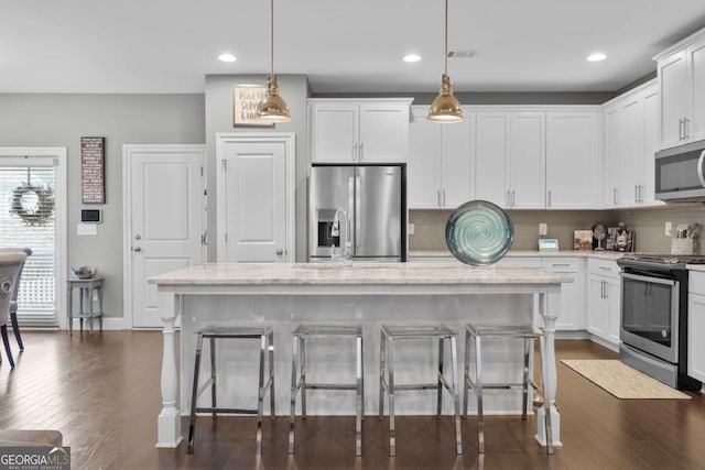 kitchen featuring a center island, pendant lighting, and appliances with stainless steel finishes