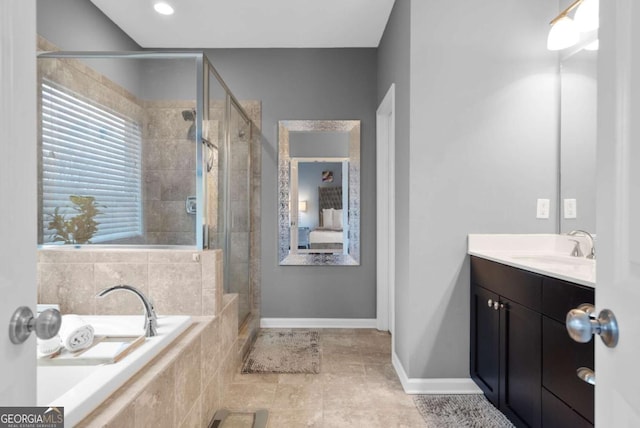 bathroom featuring plus walk in shower and vanity