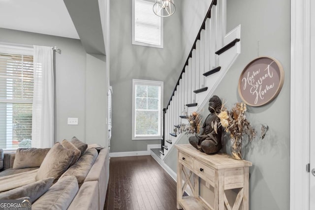 living room with dark hardwood / wood-style flooring and a high ceiling