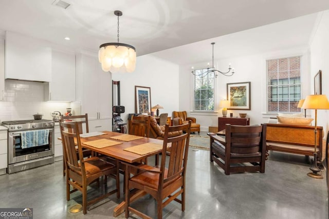 dining space with an inviting chandelier