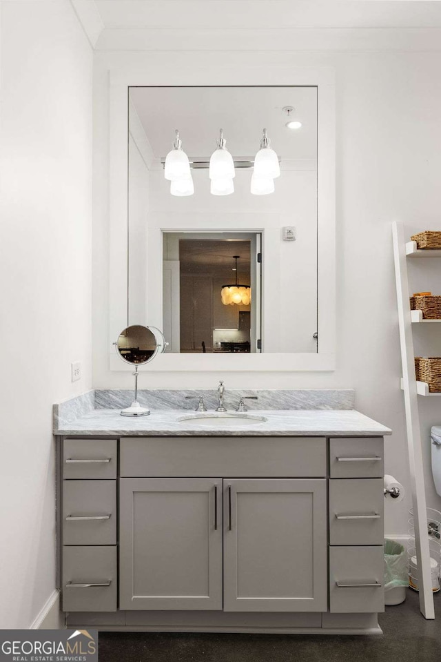 bathroom with vanity and ornamental molding