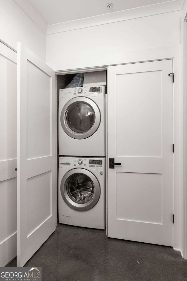 laundry room featuring stacked washing maching and dryer