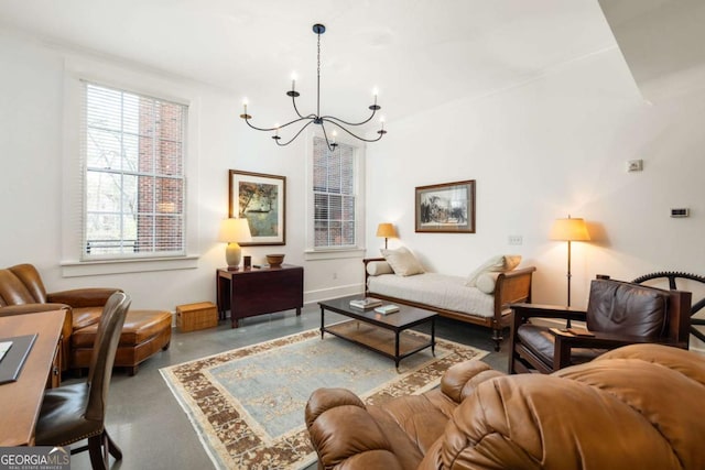 living room with a notable chandelier and concrete floors