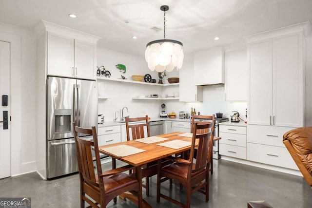 kitchen with custom range hood, stainless steel appliances, a notable chandelier, white cabinets, and hanging light fixtures