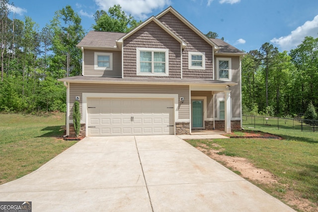 craftsman-style house featuring a garage, concrete driveway, stone siding, fence, and a front yard