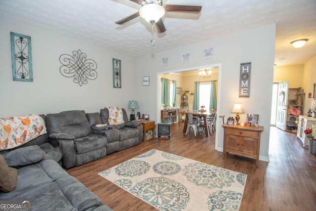 living room with a textured ceiling, hardwood / wood-style flooring, and ceiling fan