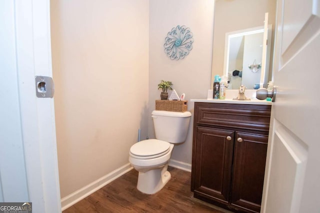 bathroom with vanity, hardwood / wood-style flooring, and toilet