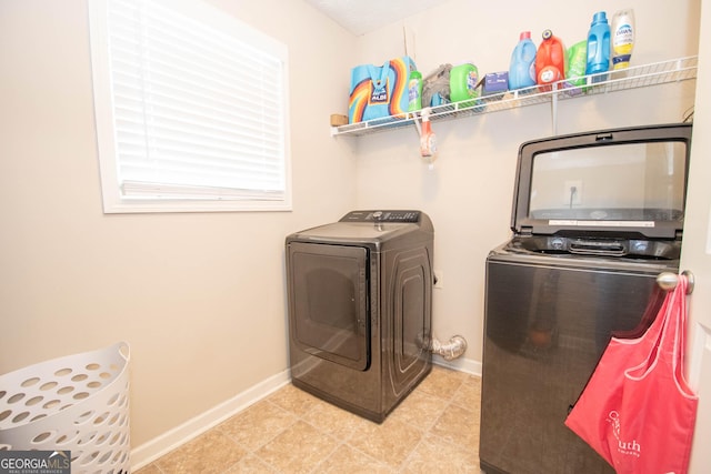 washroom with separate washer and dryer, baseboards, and laundry area