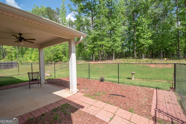 view of yard featuring a patio, ceiling fan, and fence