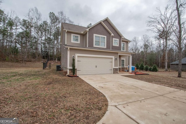 view of front of home with a garage and cooling unit