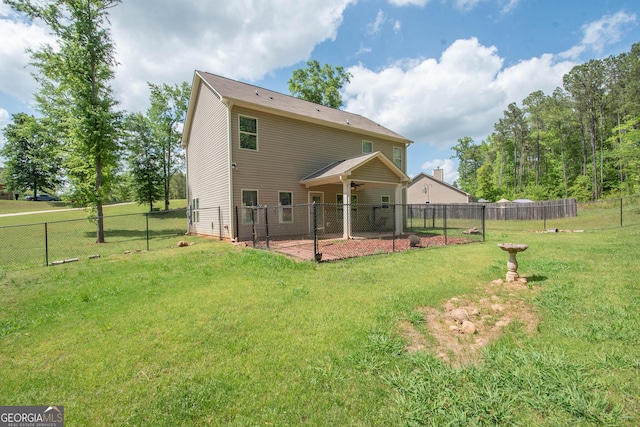 back of property with a yard, a patio, and a fenced backyard
