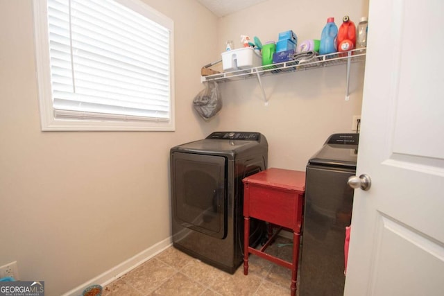 clothes washing area featuring separate washer and dryer