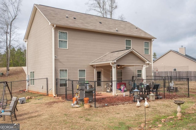 rear view of property with a yard