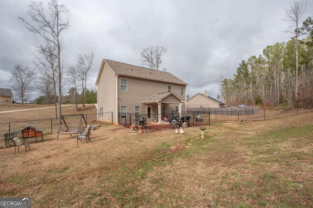 rear view of house with a yard