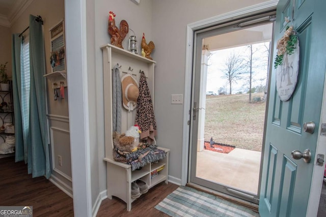 doorway to outside with crown molding and dark wood-type flooring