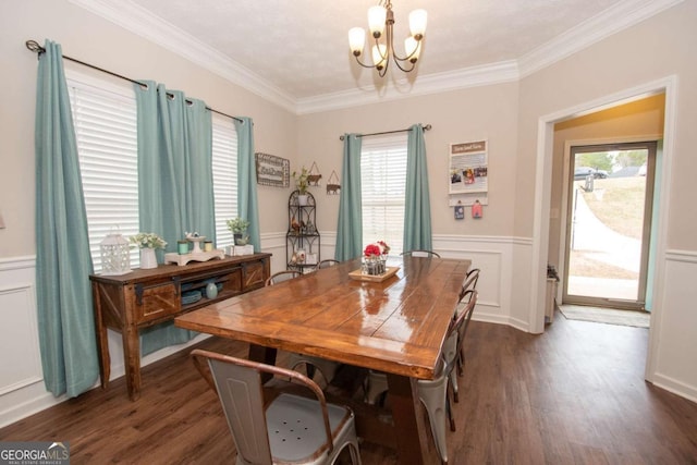 dining area featuring dark hardwood / wood-style flooring, an inviting chandelier, and ornamental molding