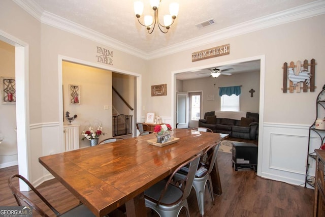 dining room featuring ornamental molding, ceiling fan with notable chandelier, and dark wood-type flooring