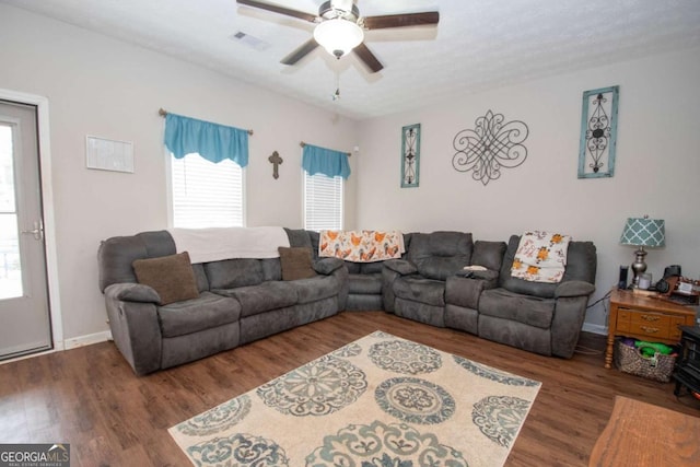 living room featuring dark hardwood / wood-style floors and ceiling fan