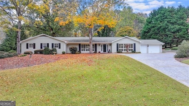 ranch-style home featuring a garage and a front yard