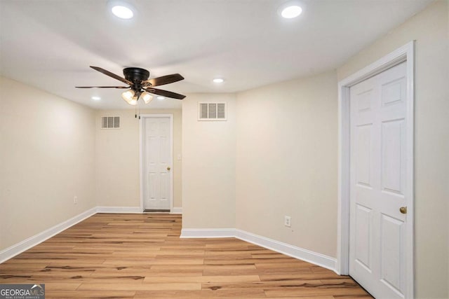 unfurnished room with ceiling fan and light wood-type flooring