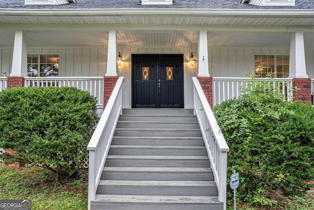 doorway to property featuring covered porch