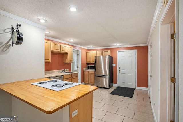 kitchen with kitchen peninsula, light tile patterned flooring, stainless steel appliances, and ornamental molding