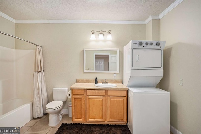 full bathroom with tile patterned floors, crown molding, stacked washer and dryer, shower / bath combo with shower curtain, and a textured ceiling