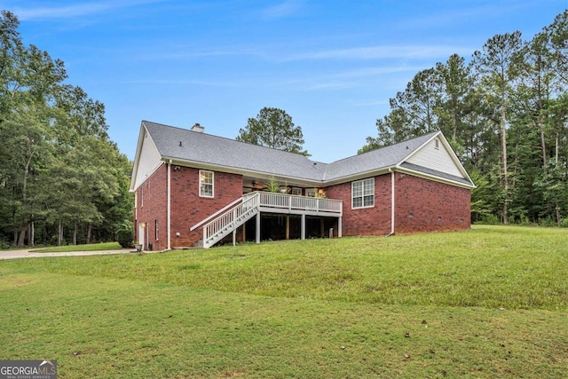 rear view of property featuring a deck and a lawn