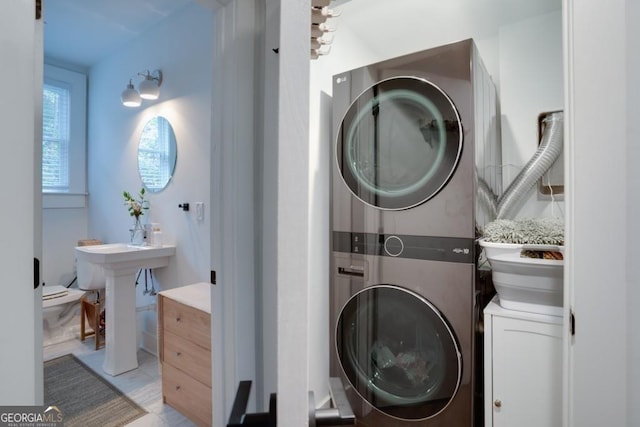 washroom featuring stacked washer and dryer