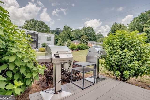 wooden deck featuring a grill