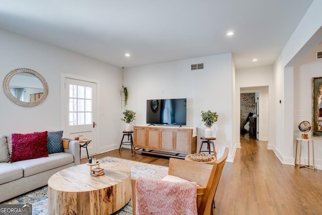 living room with light hardwood / wood-style flooring