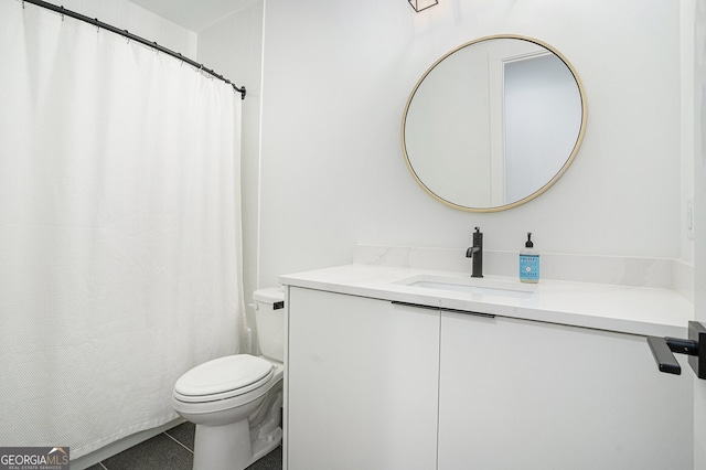 bathroom featuring toilet, vanity, and tile patterned floors