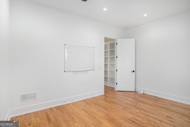 unfurnished room with light wood-type flooring