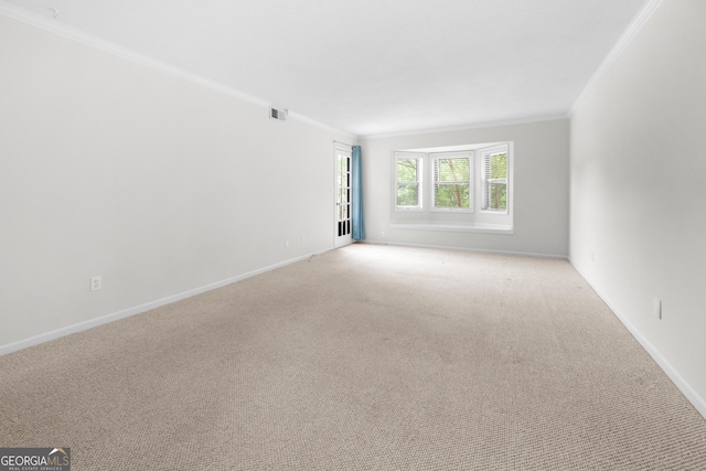 unfurnished room featuring light colored carpet and ornamental molding