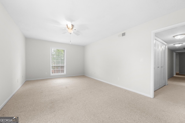 carpeted empty room with ceiling fan