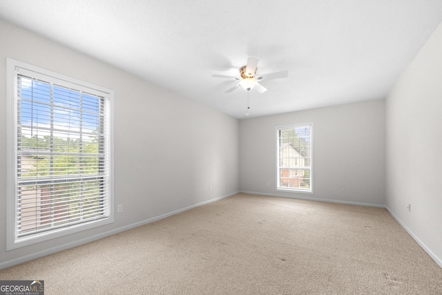 spare room with carpet flooring and ceiling fan