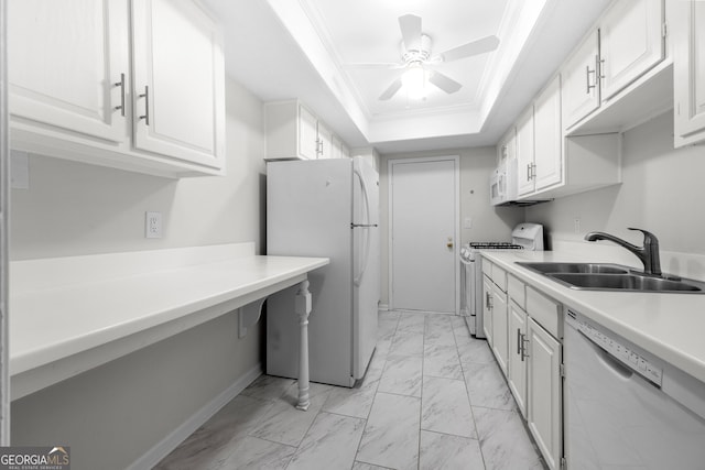 kitchen featuring white cabinetry, sink, a raised ceiling, crown molding, and white appliances