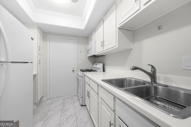 kitchen featuring sink, a raised ceiling, crown molding, white appliances, and white cabinets