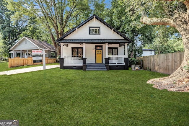 bungalow-style house with a porch and a front yard