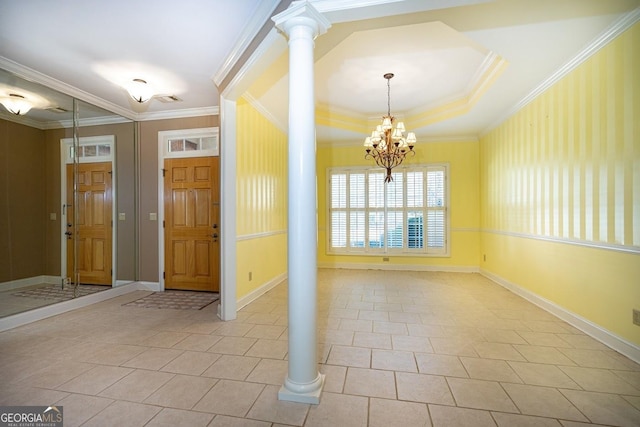 tiled foyer entrance with decorative columns, an inviting chandelier, a tray ceiling, and crown molding