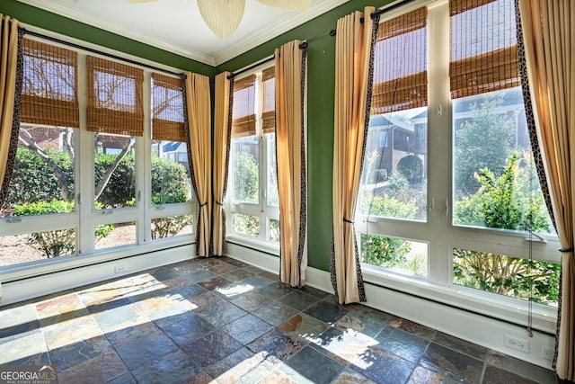 doorway with ceiling fan, crown molding, and a baseboard heating unit