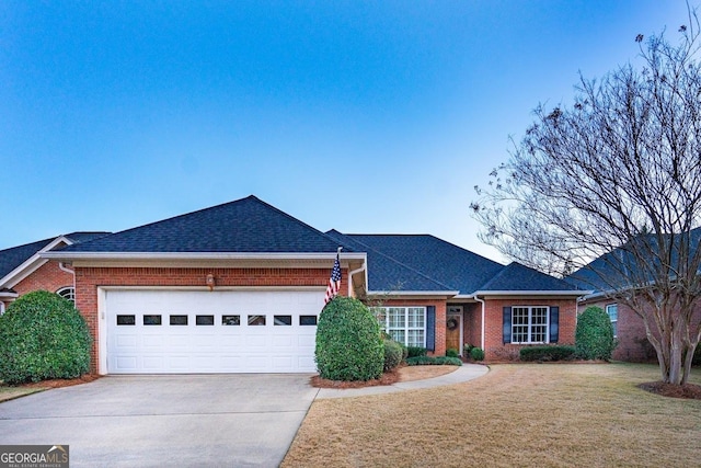 ranch-style house featuring a front lawn and a garage