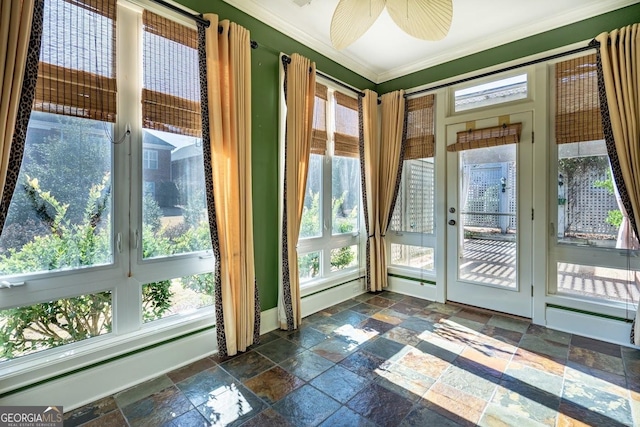 doorway to outside featuring ceiling fan and ornamental molding