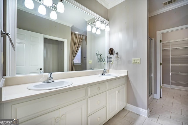 bathroom with tile patterned floors, vanity, an enclosed shower, and crown molding