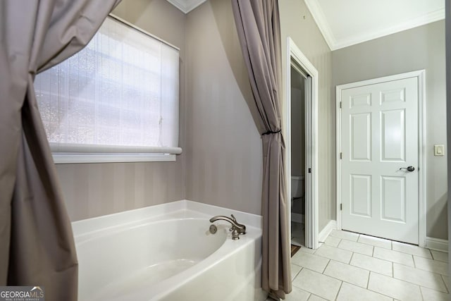 bathroom with tile patterned floors, crown molding, plenty of natural light, and a bathing tub