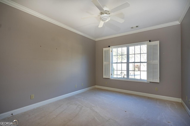 carpeted spare room with ceiling fan and ornamental molding