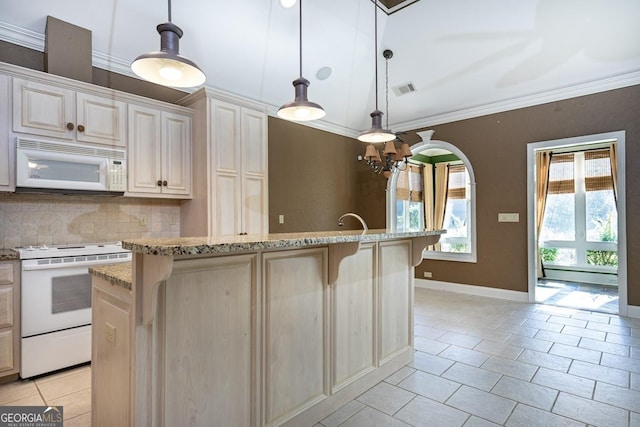 kitchen with pendant lighting, decorative backsplash, white appliances, and an island with sink