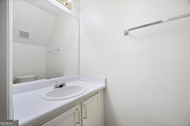 bathroom featuring vanity and toilet