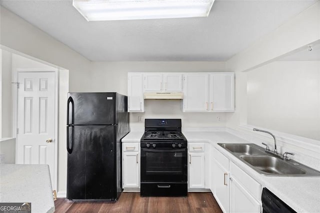 kitchen with dark hardwood / wood-style flooring, sink, white cabinets, and black appliances